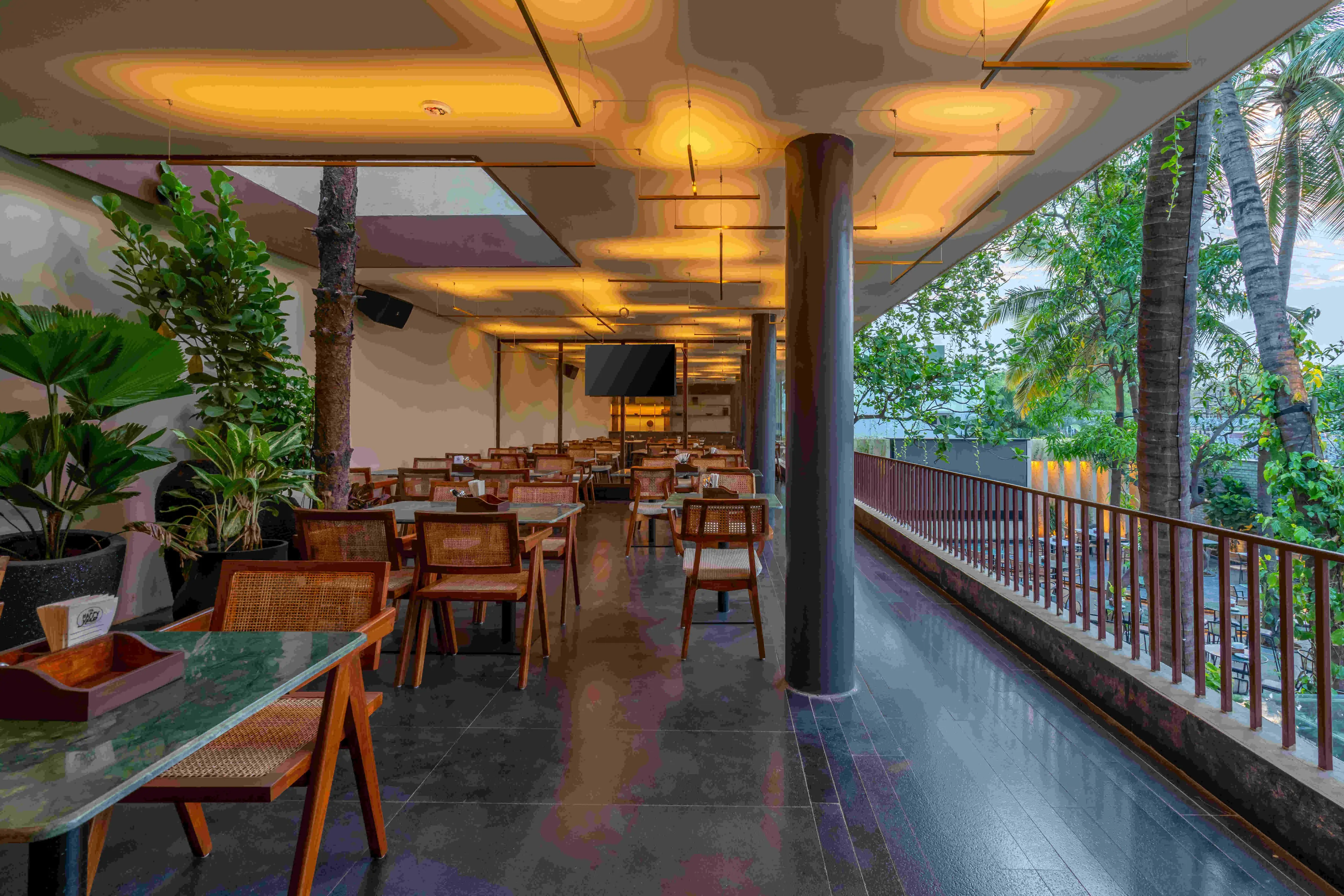Tables along the open side of the covered room.