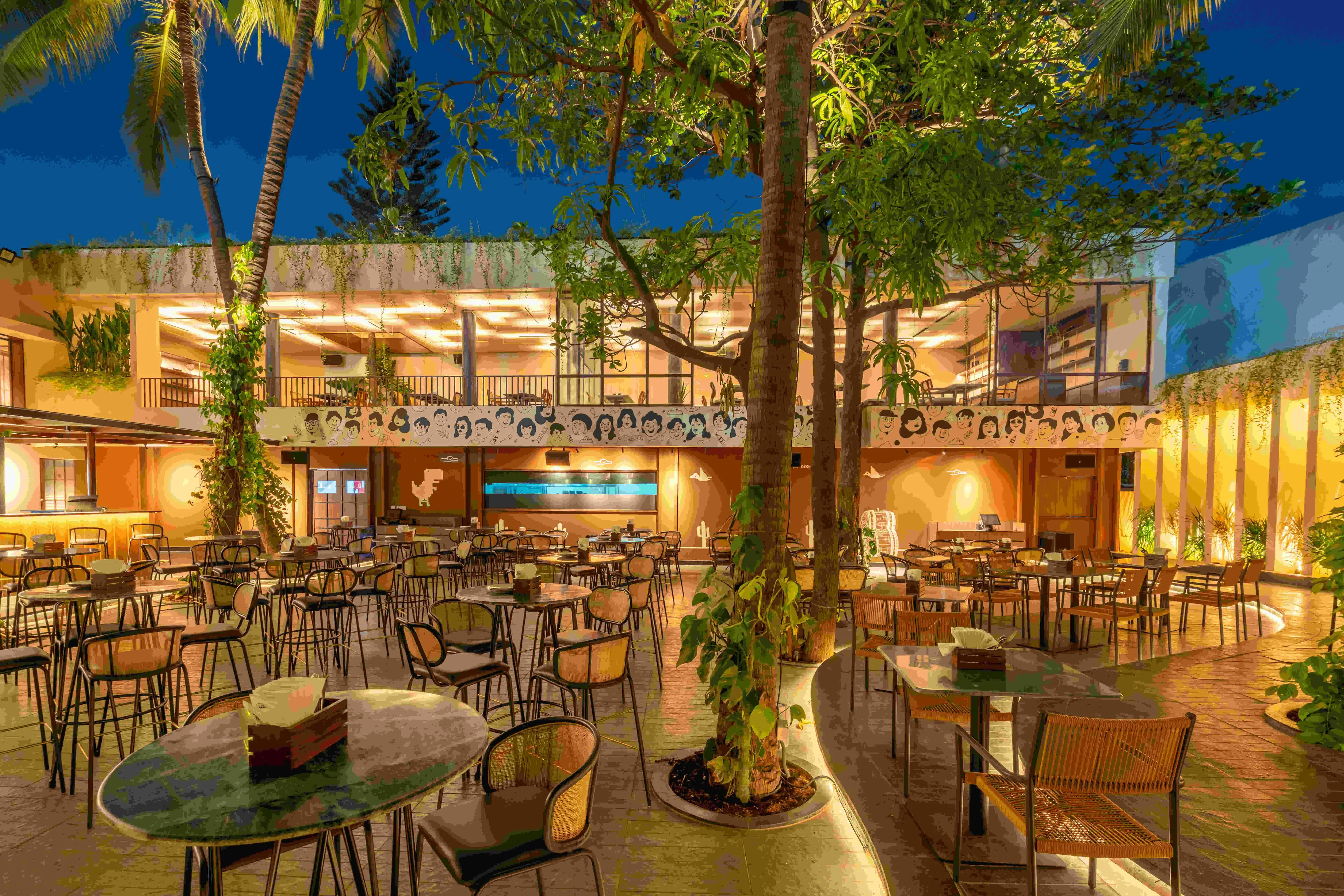 The whole yard at blue hour, every level lit.