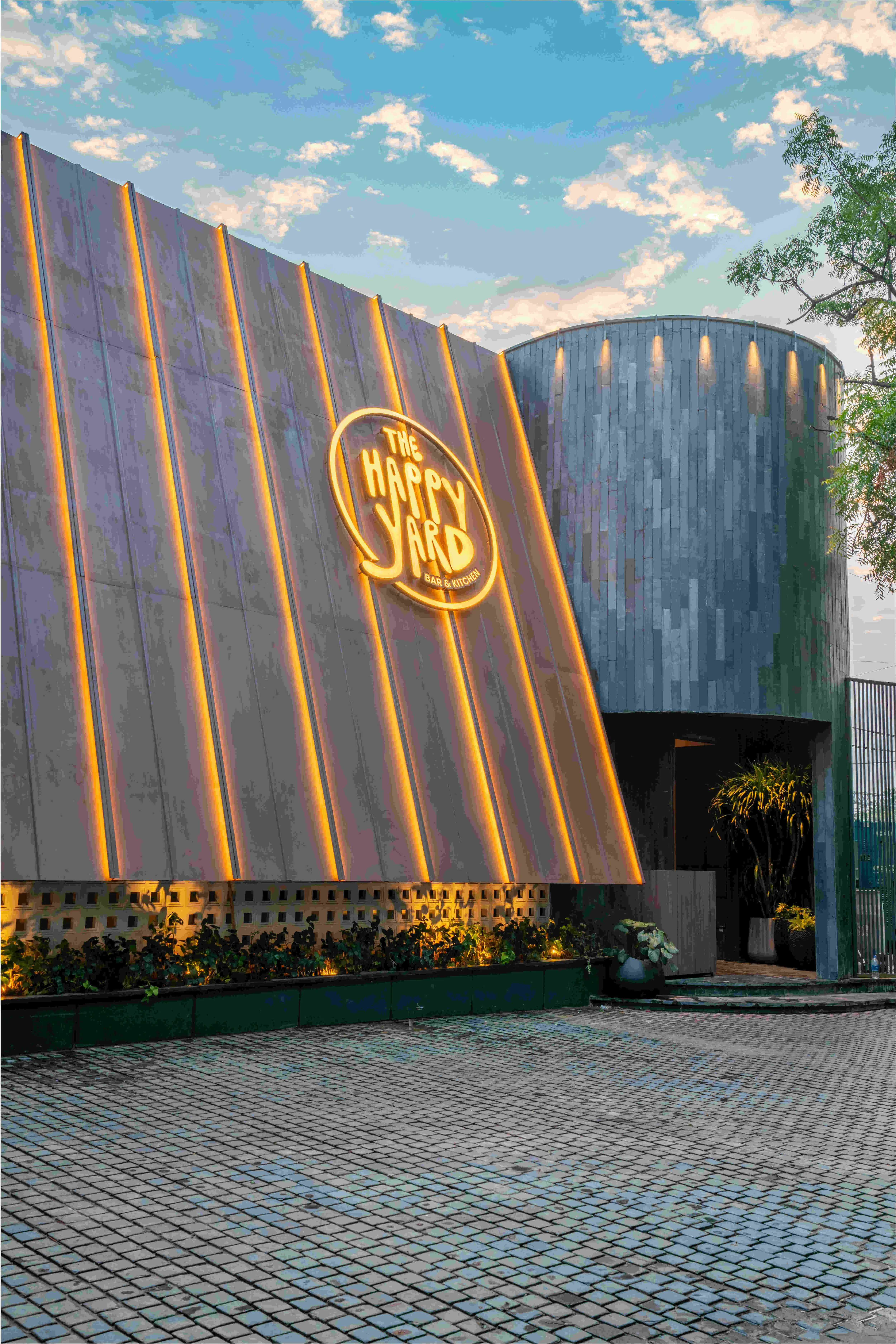 The entrance and the curved lit wall from the street.